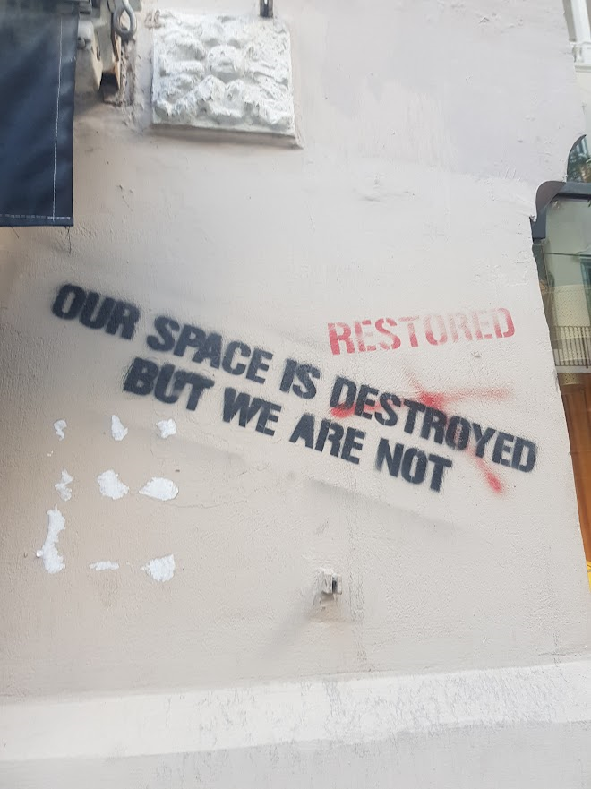 Graffiti on a wall in Beirut, which reads 'Our space is destroyed but we are not'. 