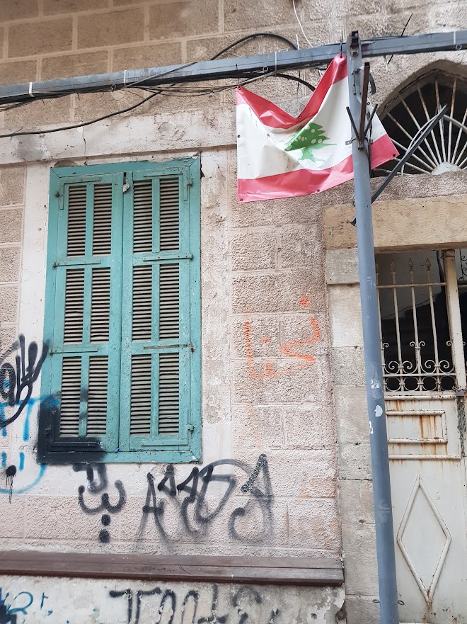 The Lebanese flag on a building in a neighbourhood in Beirut. The photo was taken October 2023.