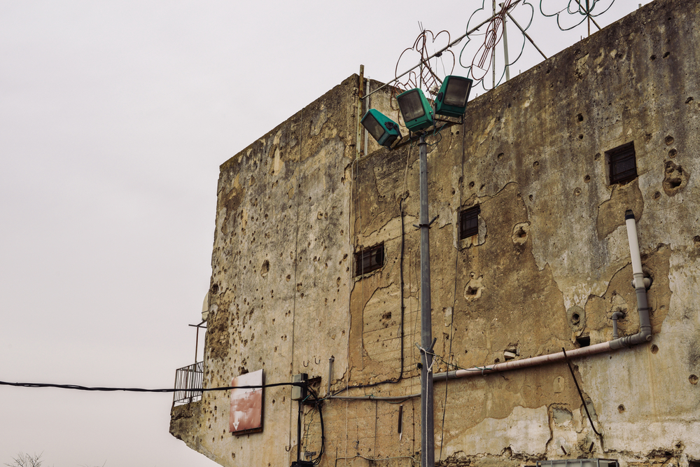Bullet holes in the wall of a building on the border between Israel and Lebanon from the 1982 war