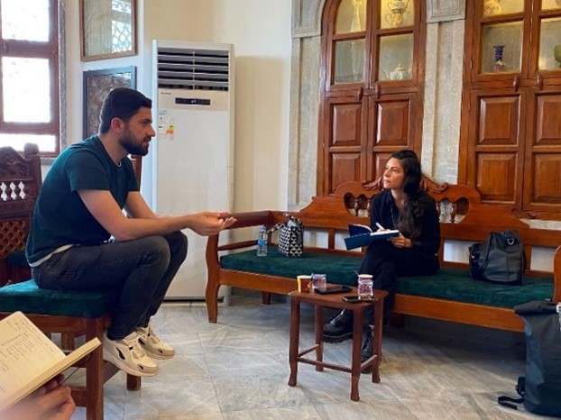 Ayoub Thanoon and Inna Rudolf sit talking at Mosul Heritage House