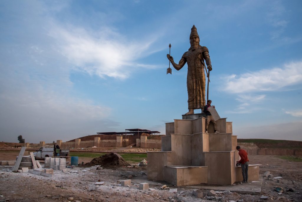 Workers putting the finishing touches to a statue of King Synchrib